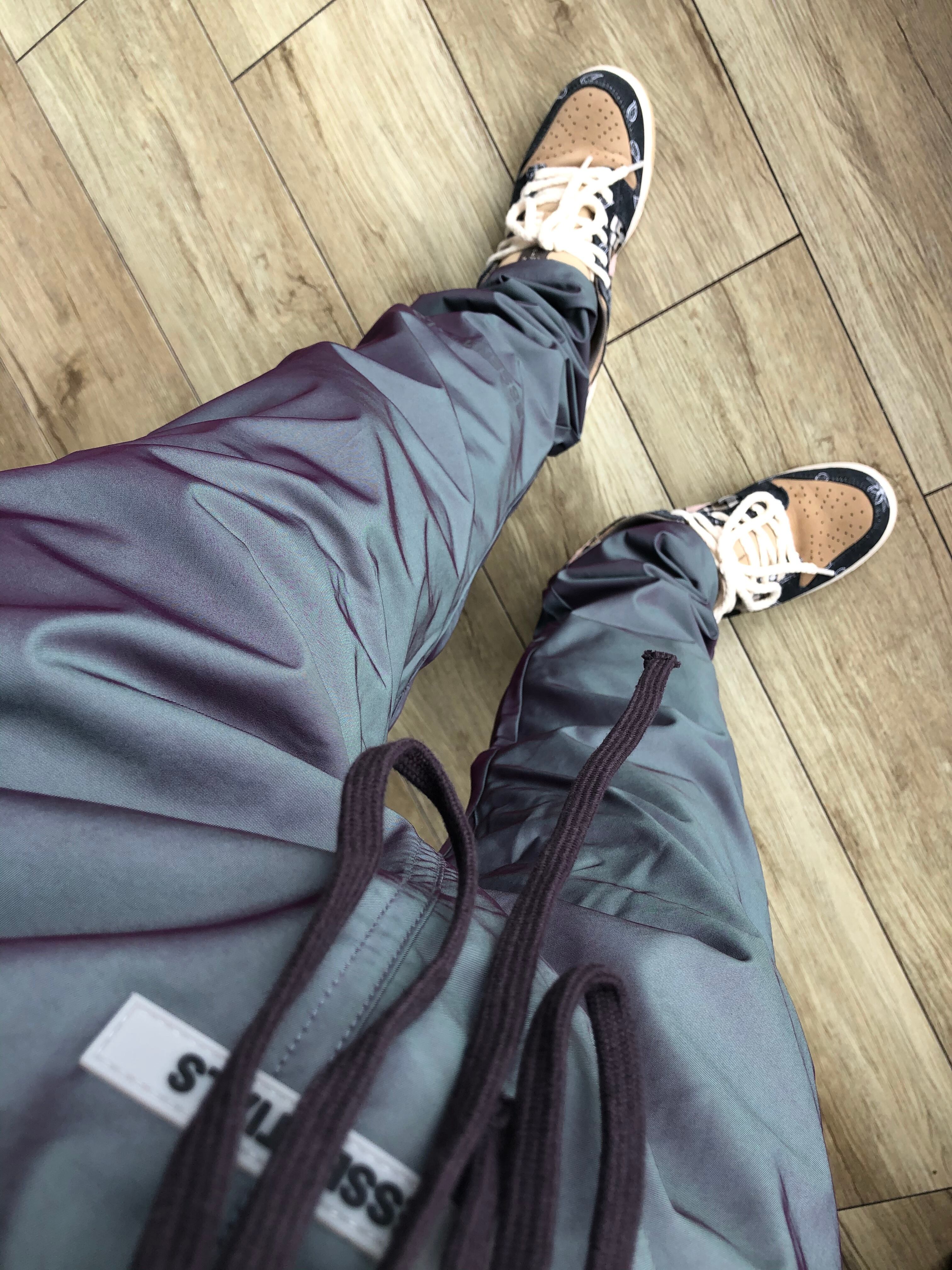 FOG fear of god ESSENTIALS Iridescent Nylon Track Pants | THE HOOK