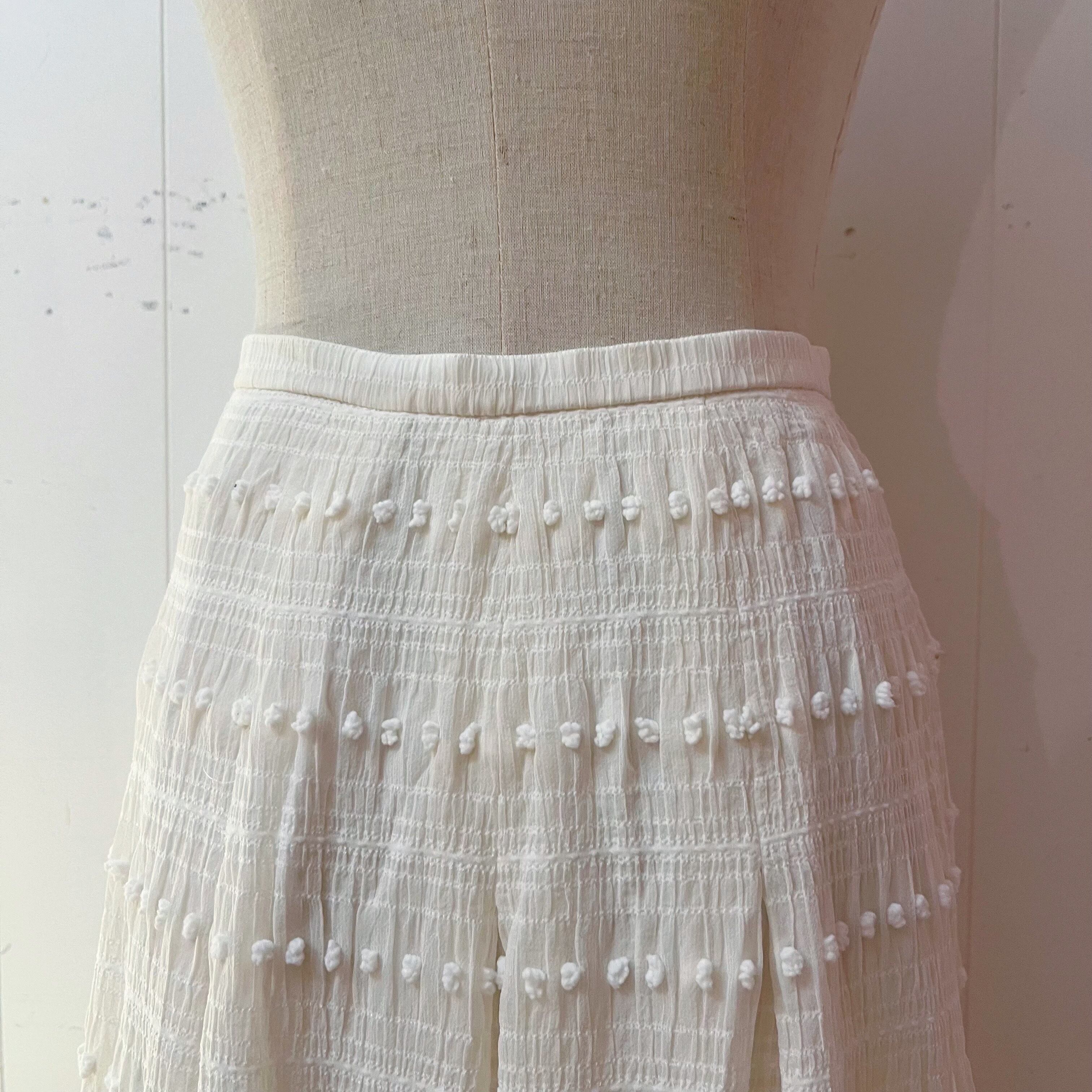 NINARICCI / mini ponpon white flare skirt