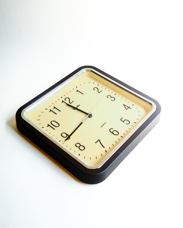 A simple wall clock with a gray frame