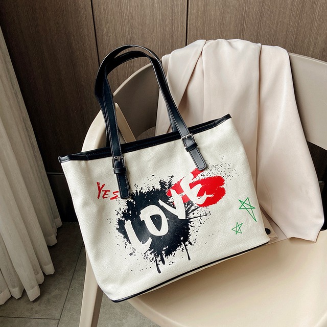 シンプルで大容量のバッグハンドバッグ2020新しいトレンディなファッションワイルドインセングラフィティキャンバストートバッグ Tiancai_Wing_Bag3792357