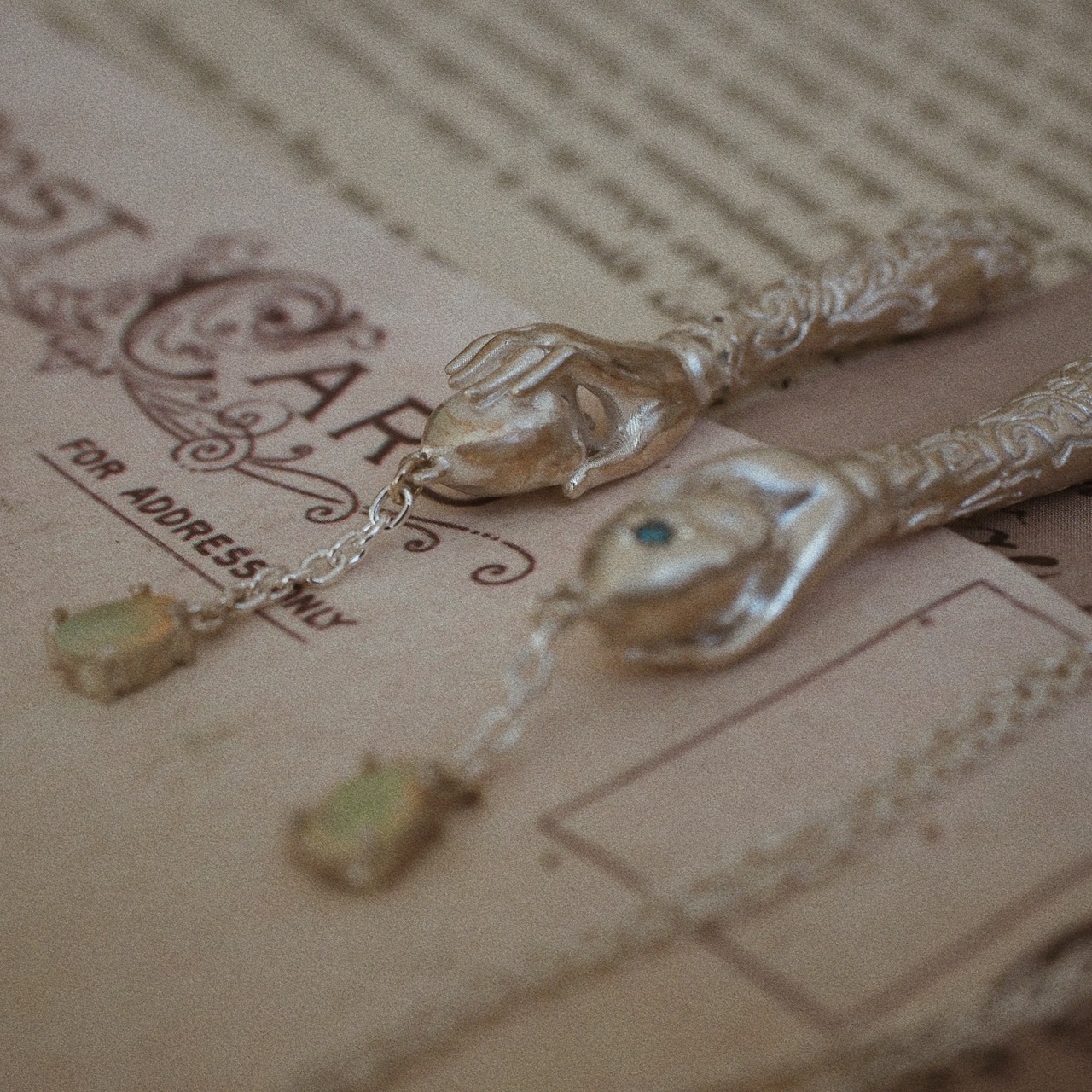 silver necklace of spherically-articulated dolls