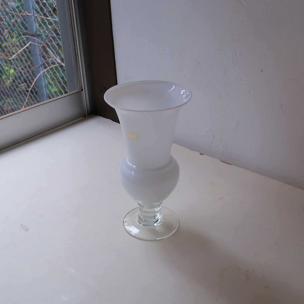 透明な脚の白い花瓶