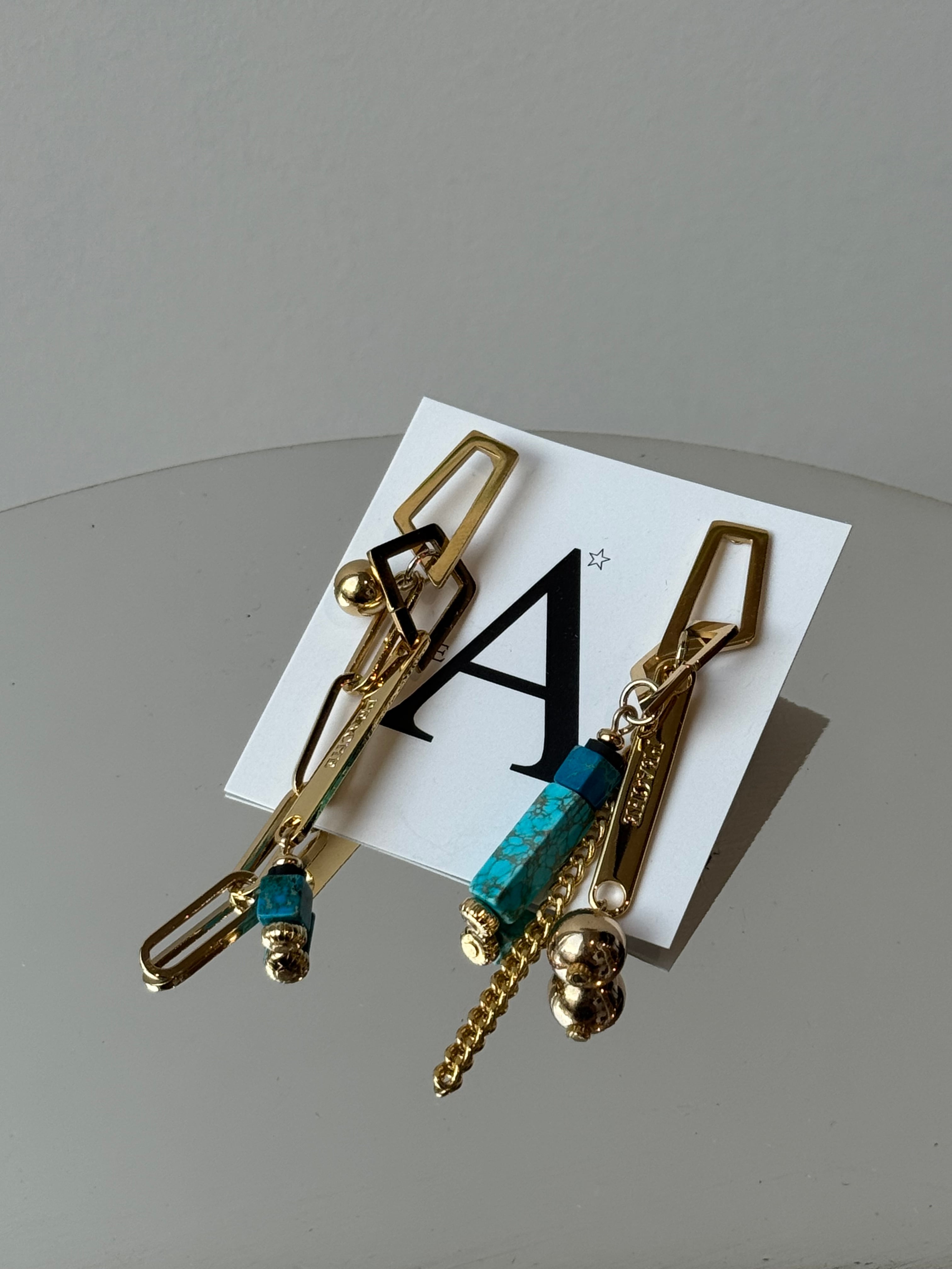 random chain design gold turquoise asymmetry