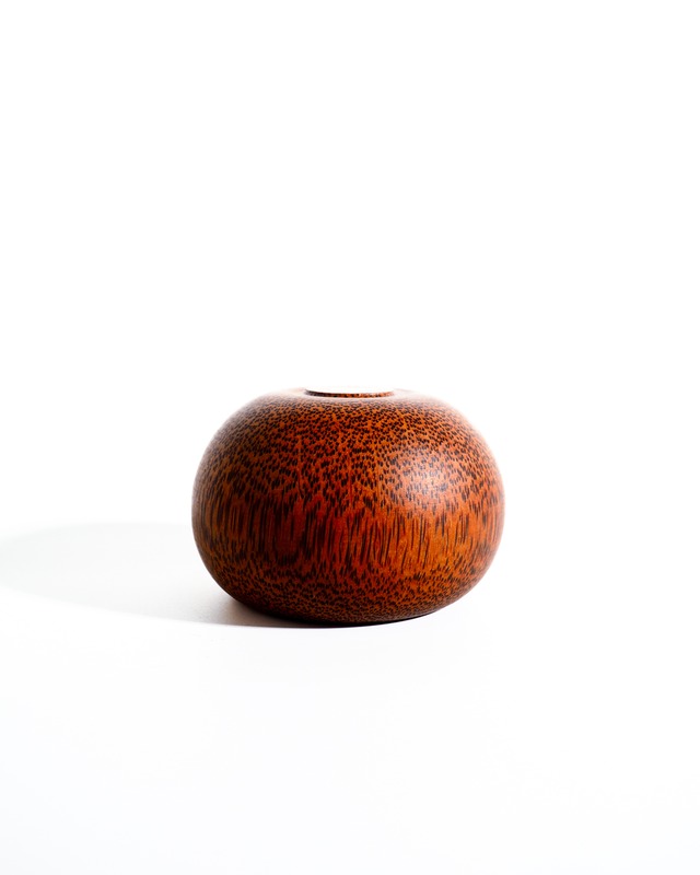 A small container or ashtray reddish-brown color spots