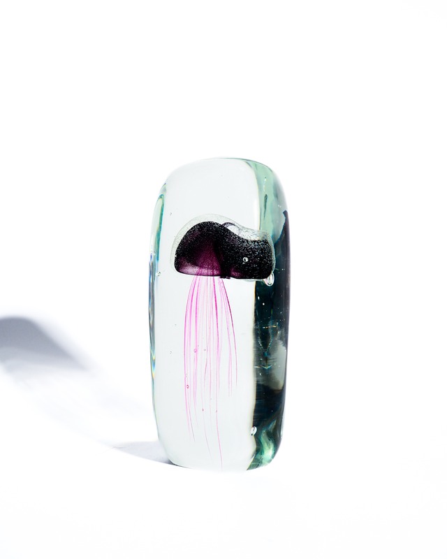A paperweight object containing a glass jellyfish
