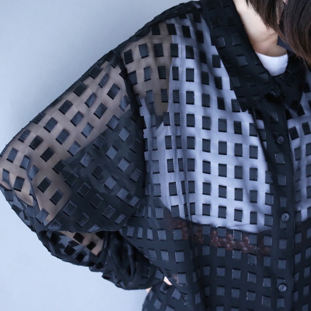 block pattern XXX over silhouette black see-through shirt