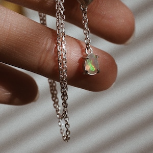 silver necklace of spherically-articulated dolls