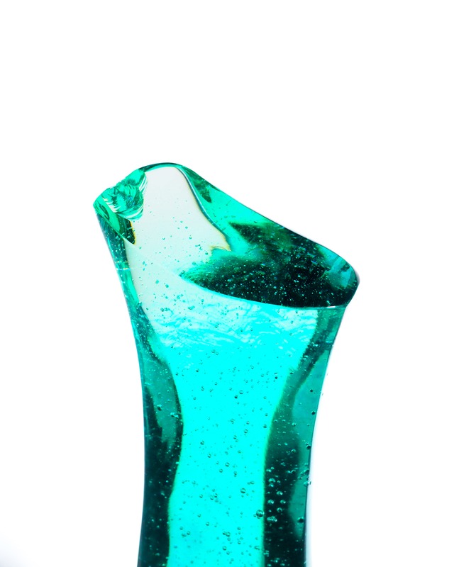 A streamlined, turquoise-blue glass object