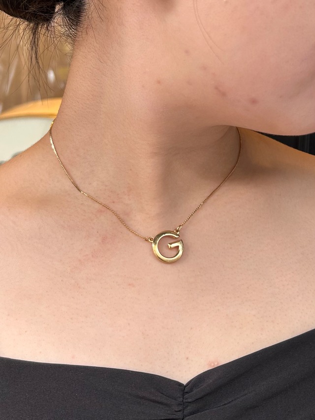 GIVENCHY / vintage gold "G" design necklace.