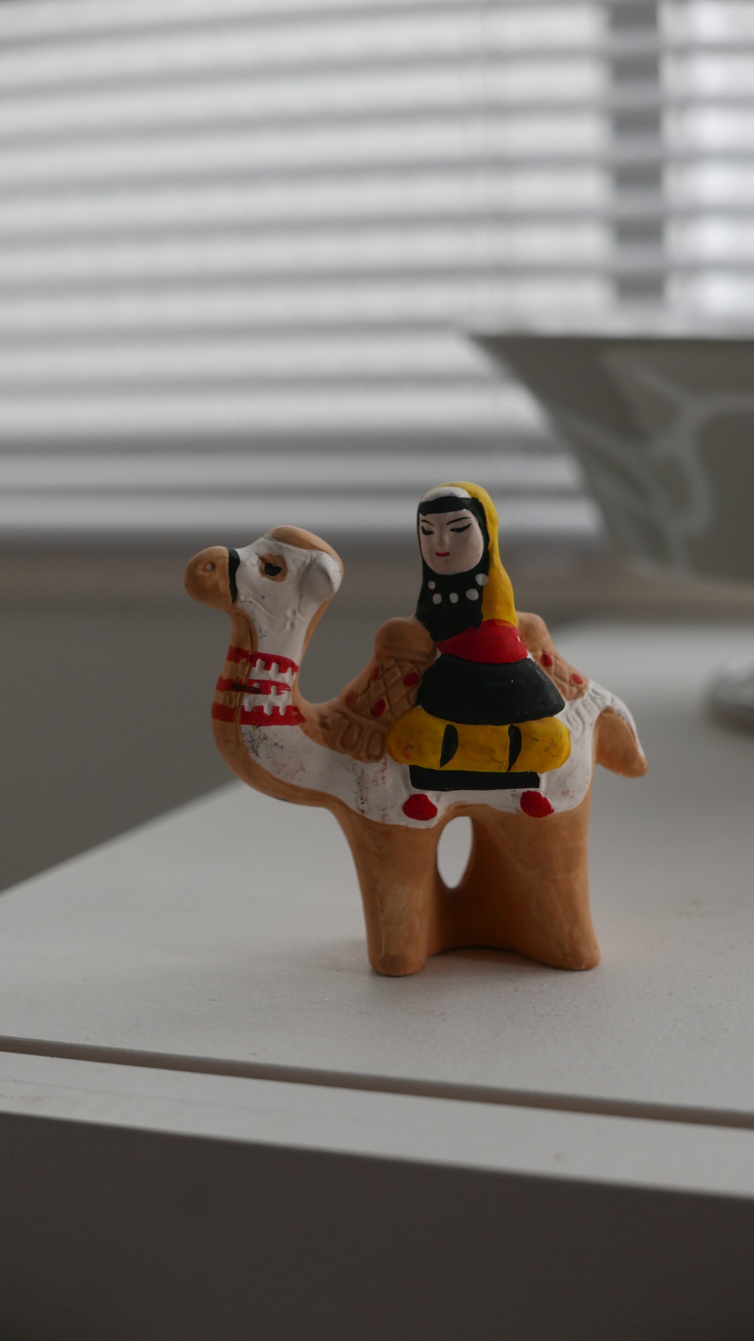 pottery object , camel and woman