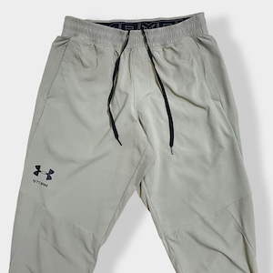 【UNDER ARMOUR】ウインドブレーカーパンツ トレーニングパンツ ジャージ ズボン 裾チャック 裾ジップ ポリエステル ロゴプリント M 蛍光色 アンダーアーマー US古着