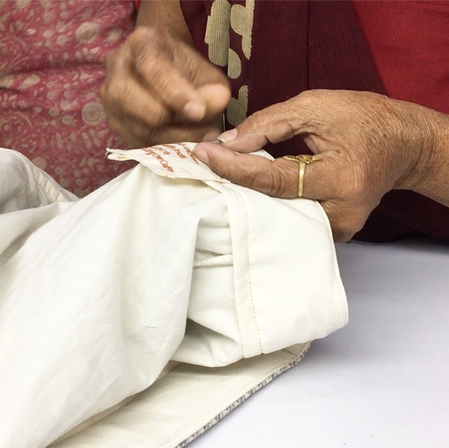 Hand-embroidery of custom-made letters on baby towels