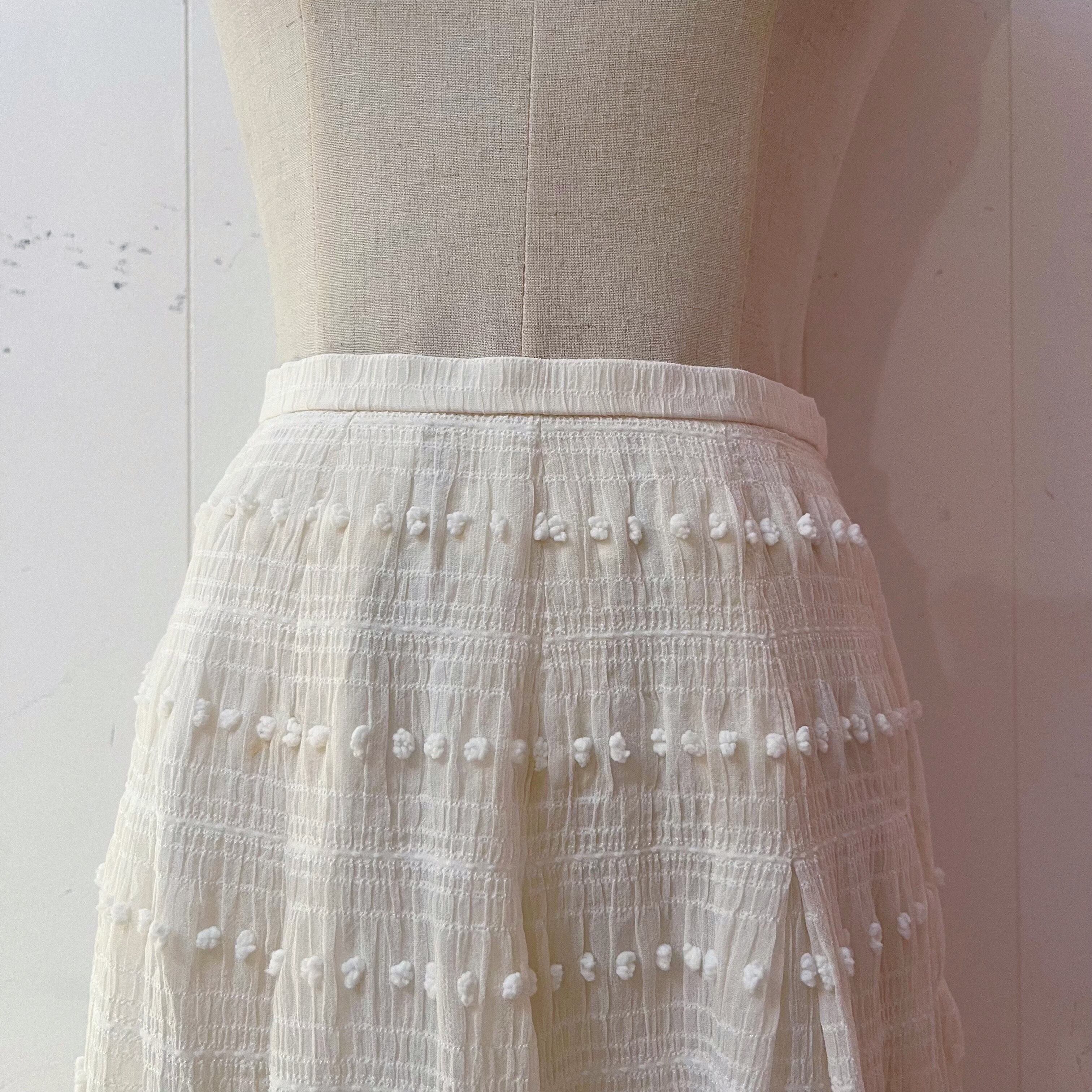 NINARICCI / mini ponpon white flare skirt