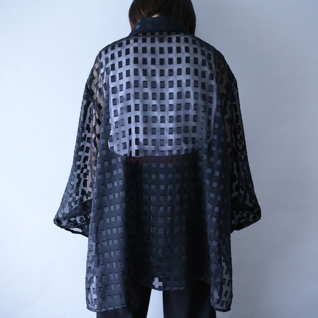 block pattern XXX over silhouette black see-through shirt