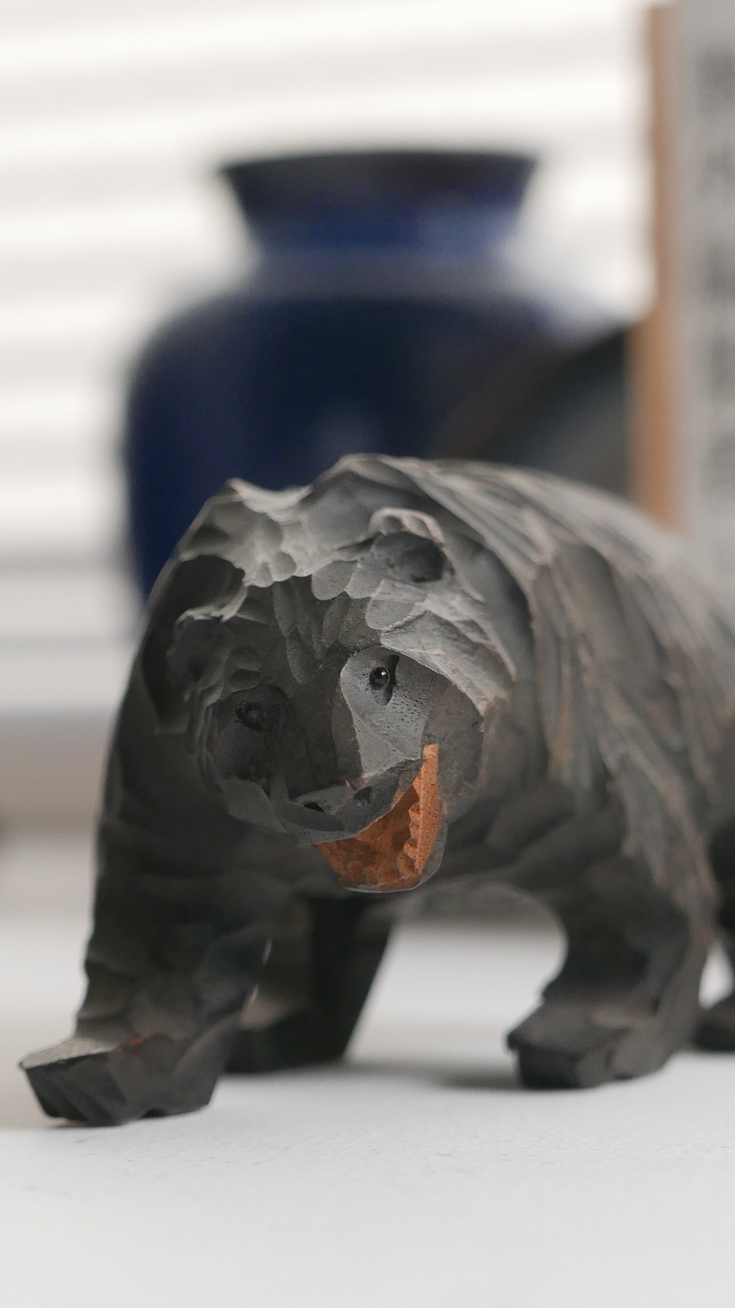 small wooden bear , tiny eyes