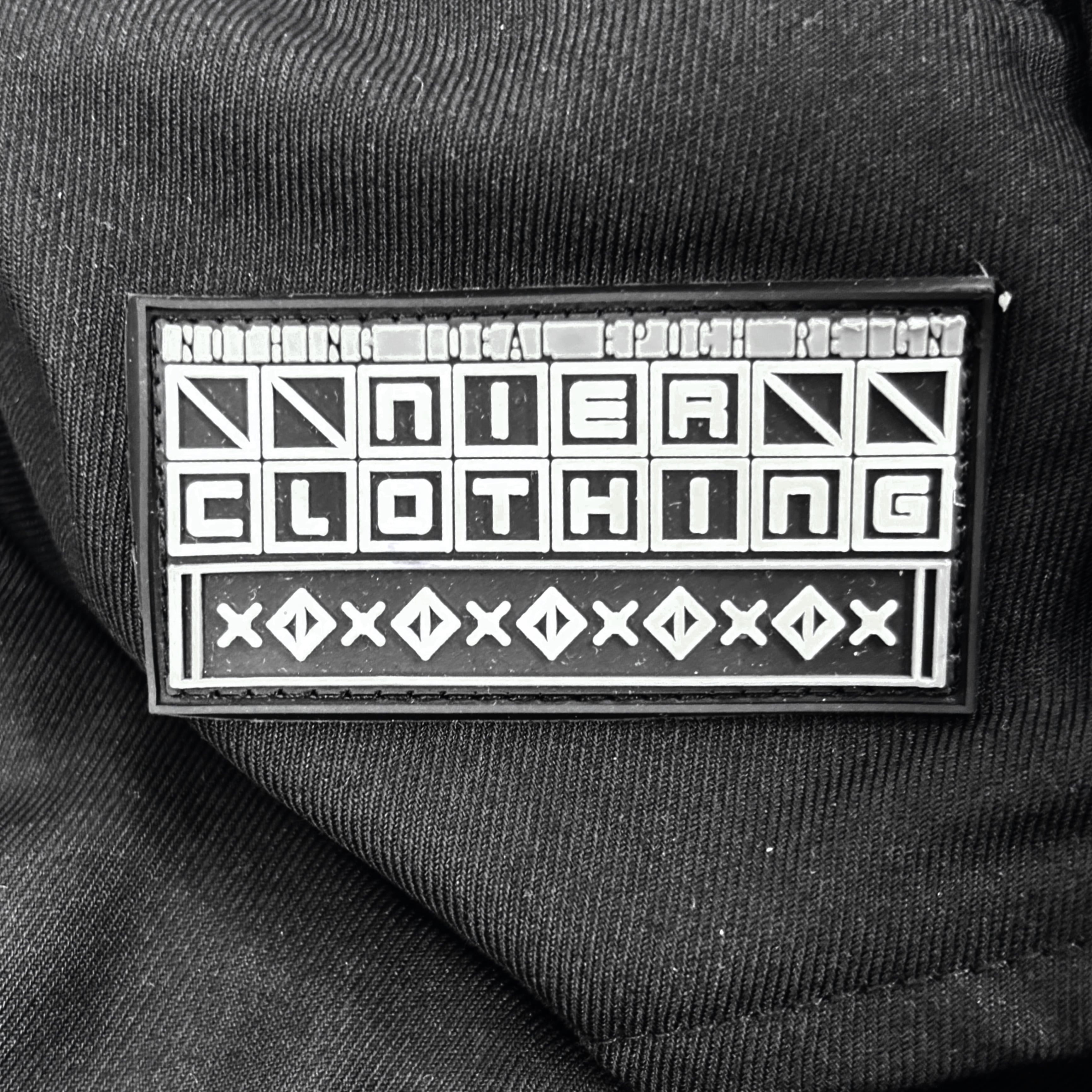 フード付きBLACK HIGHNECK SPRING LONG COAT【RUBBER LOGO】 | NIER