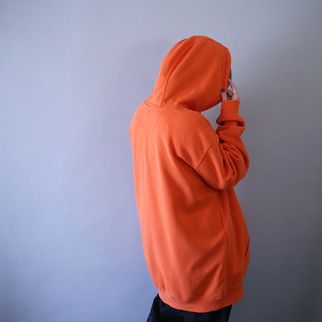 "Carhartt" sleeve logo printed over silhouette orange sweat parka