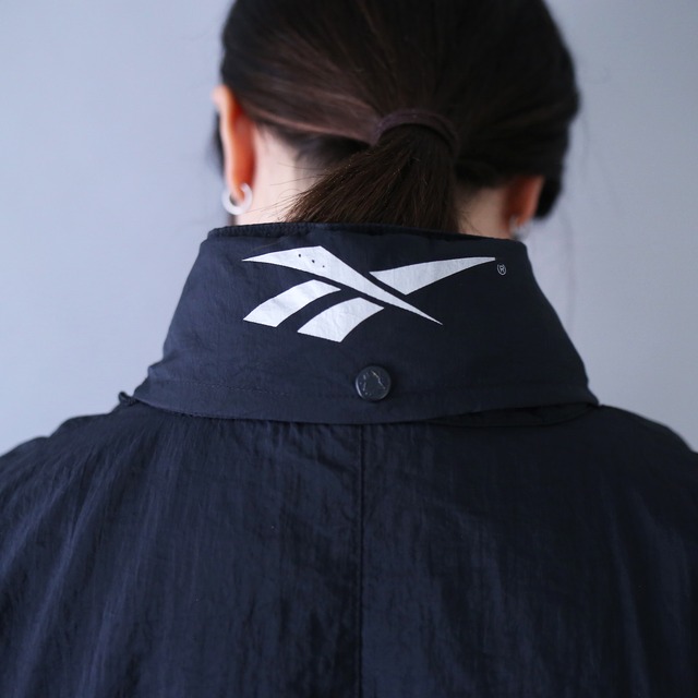 "Reebok" sleeve embroidery logo design over silhouette monotone nylon anorak