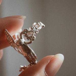 Silver ring of spherically-articulated dolls