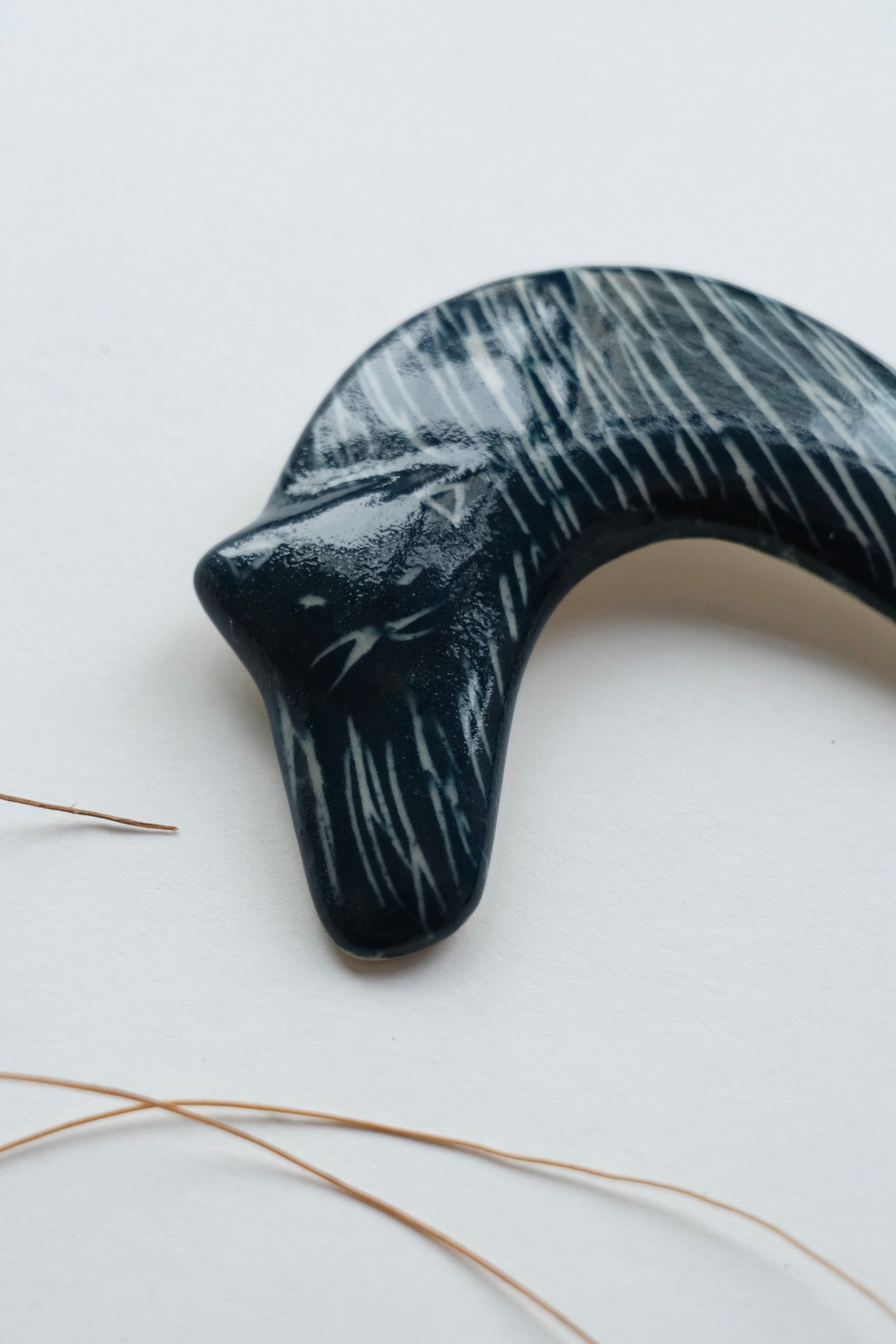 Handmade ceramic crescent cat brooch