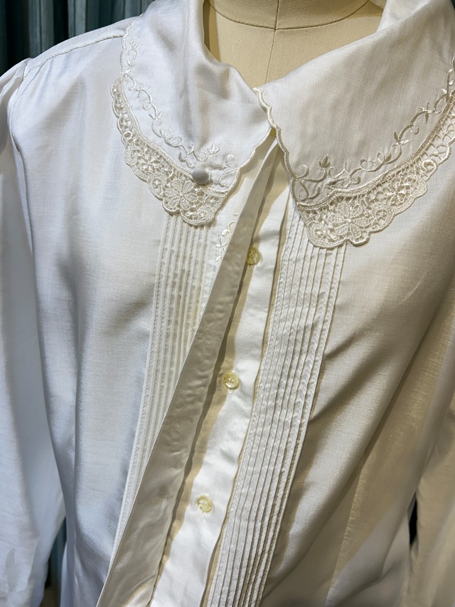 white embroidery pin tuck blouse