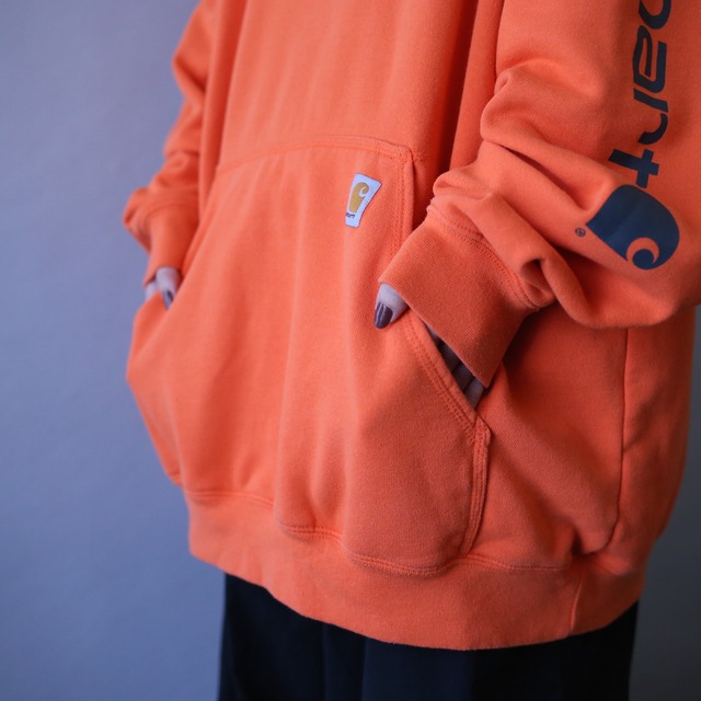 "Carhartt" sleeve logo printed over silhouette orange sweat parka