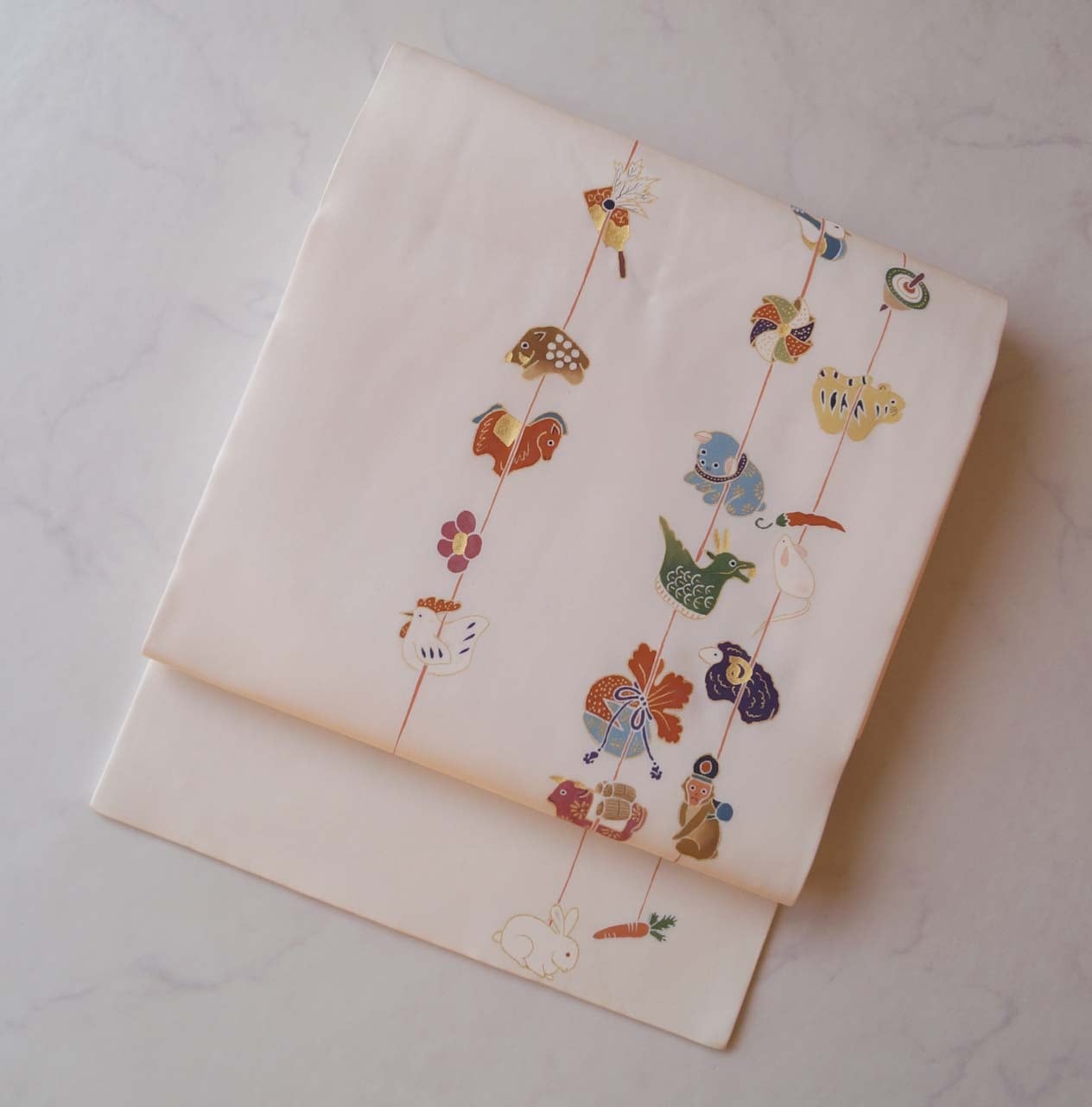 【なごや帯】生成り地 つるし雛の干支飾り 塩瀬なごや帯