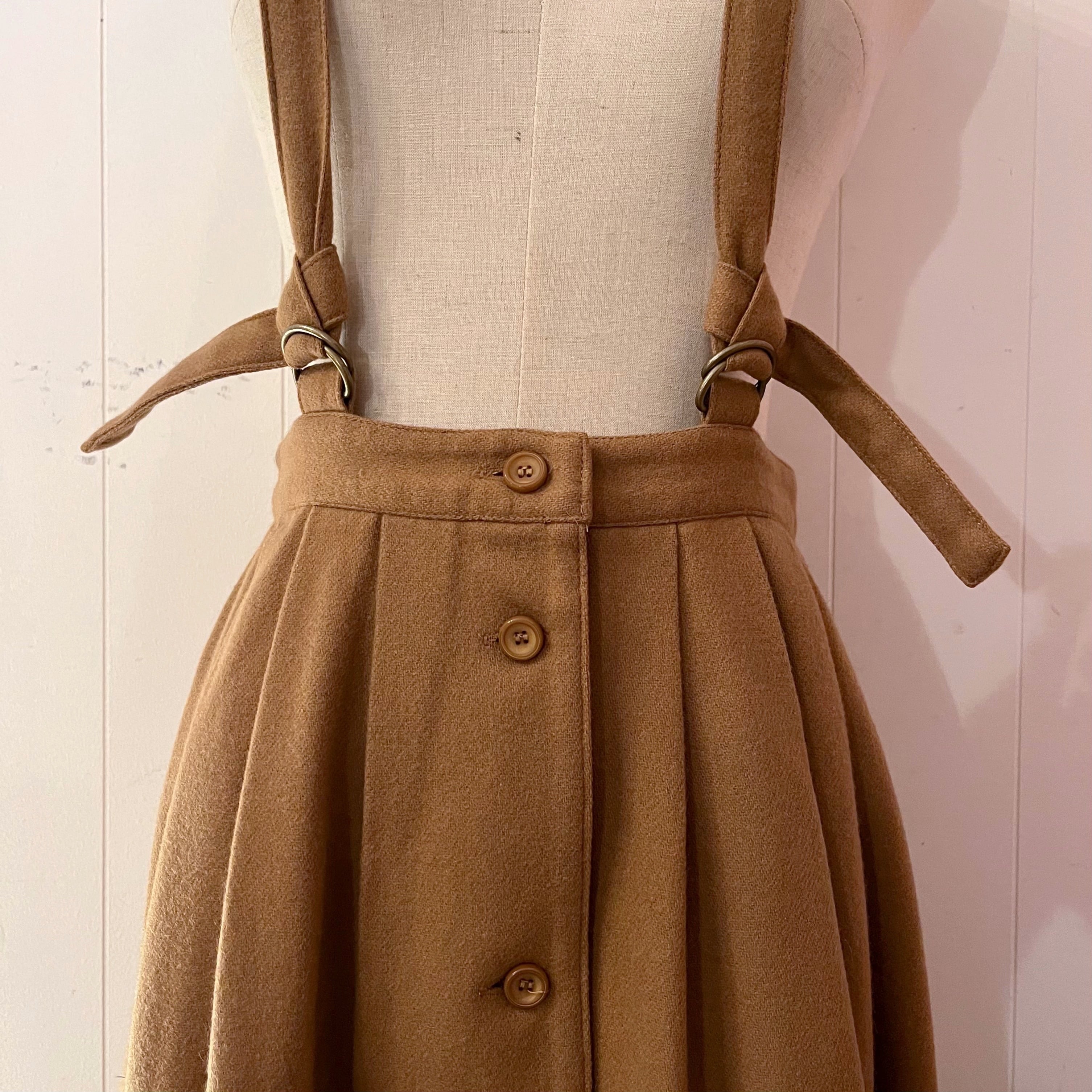 beige front button suspender skirt