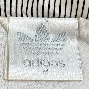 【adidas】90s トラックジャケット ジャンパー ブルゾン 刺繍ロゴ フルジップ バックプリント 切替 銀タグ 万国旗タグ アディダス US古着