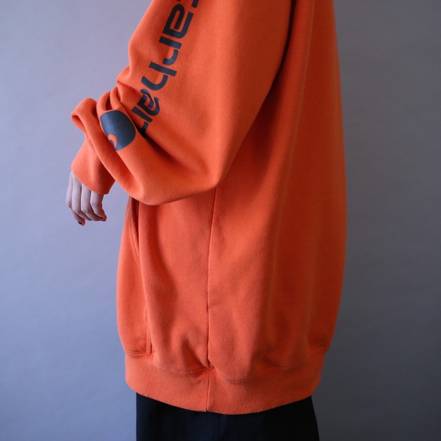 "Carhartt" sleeve logo printed over silhouette orange sweat parka