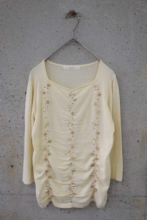 Knit top with seashell bead embellishment