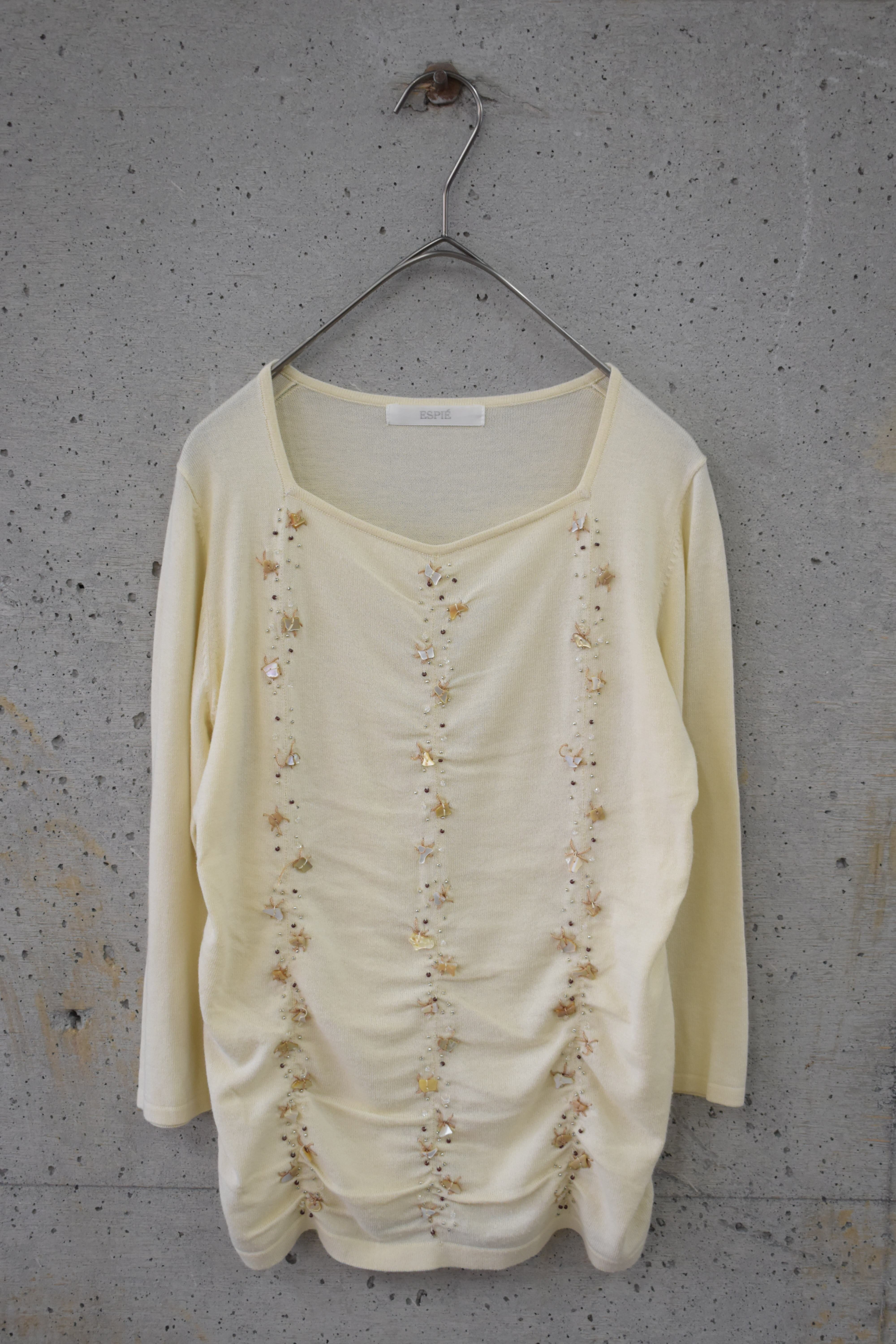 Knit top with seashell bead embellishment