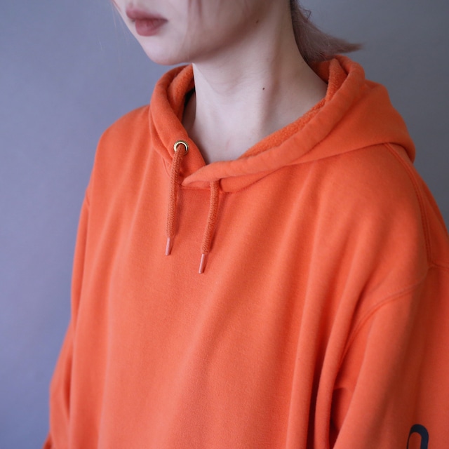 "Carhartt" sleeve logo printed over silhouette orange sweat parka