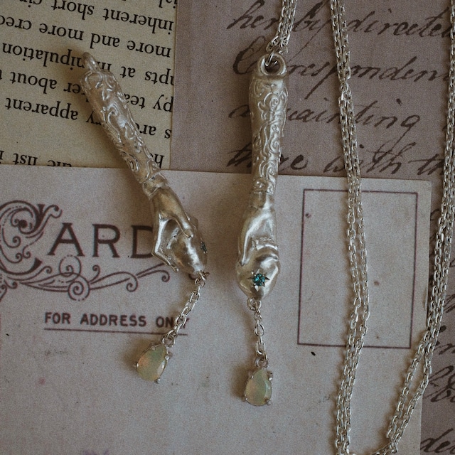 silver necklace of spherically-articulated dolls