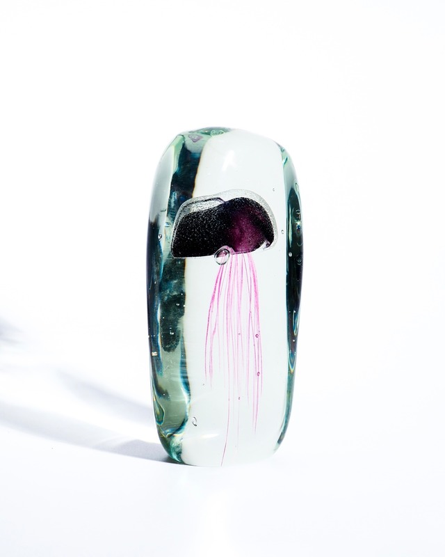 A paperweight object containing a glass jellyfish