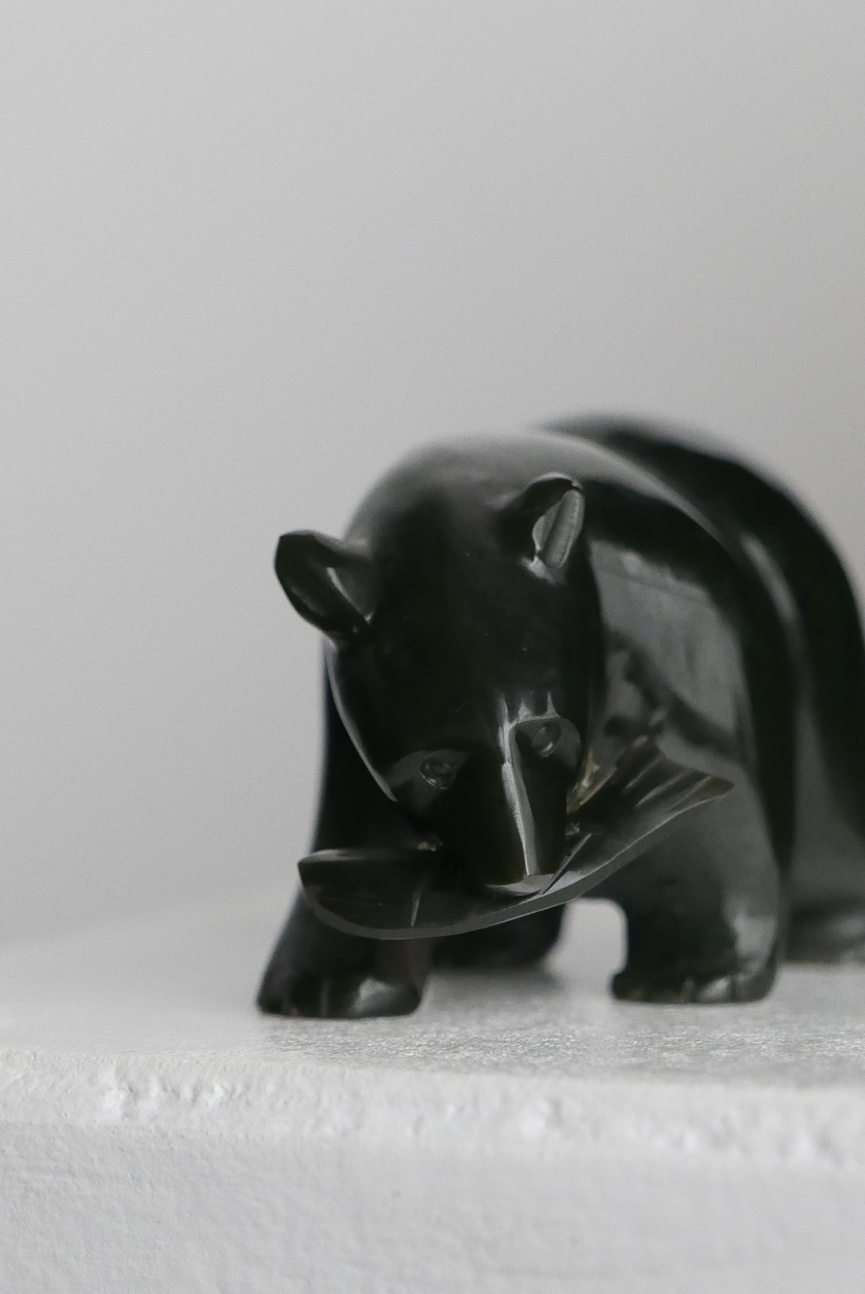 stone carving bear , black and smooth