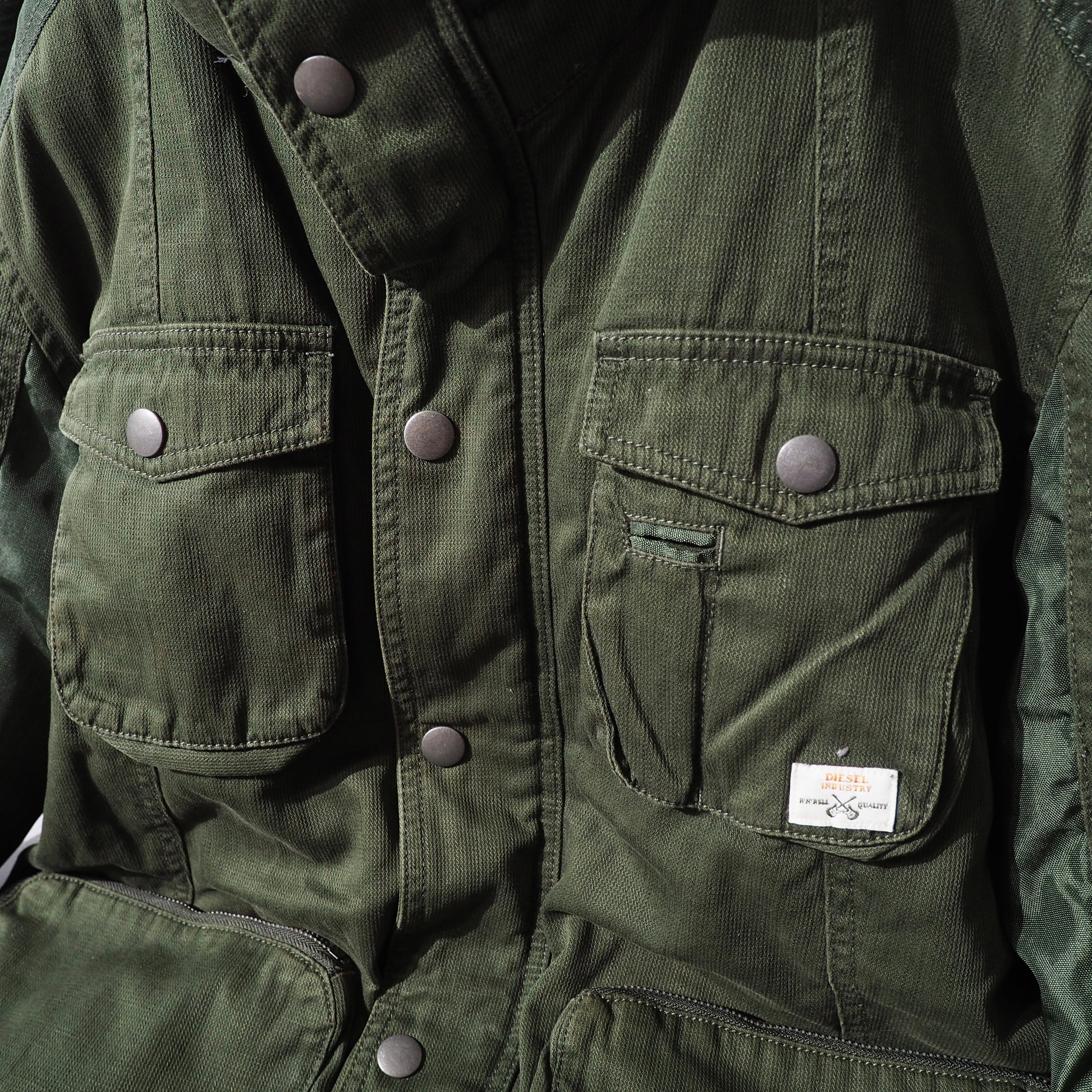 " DIESEL " Big Pockets × Switching nylon High neck Military jacket