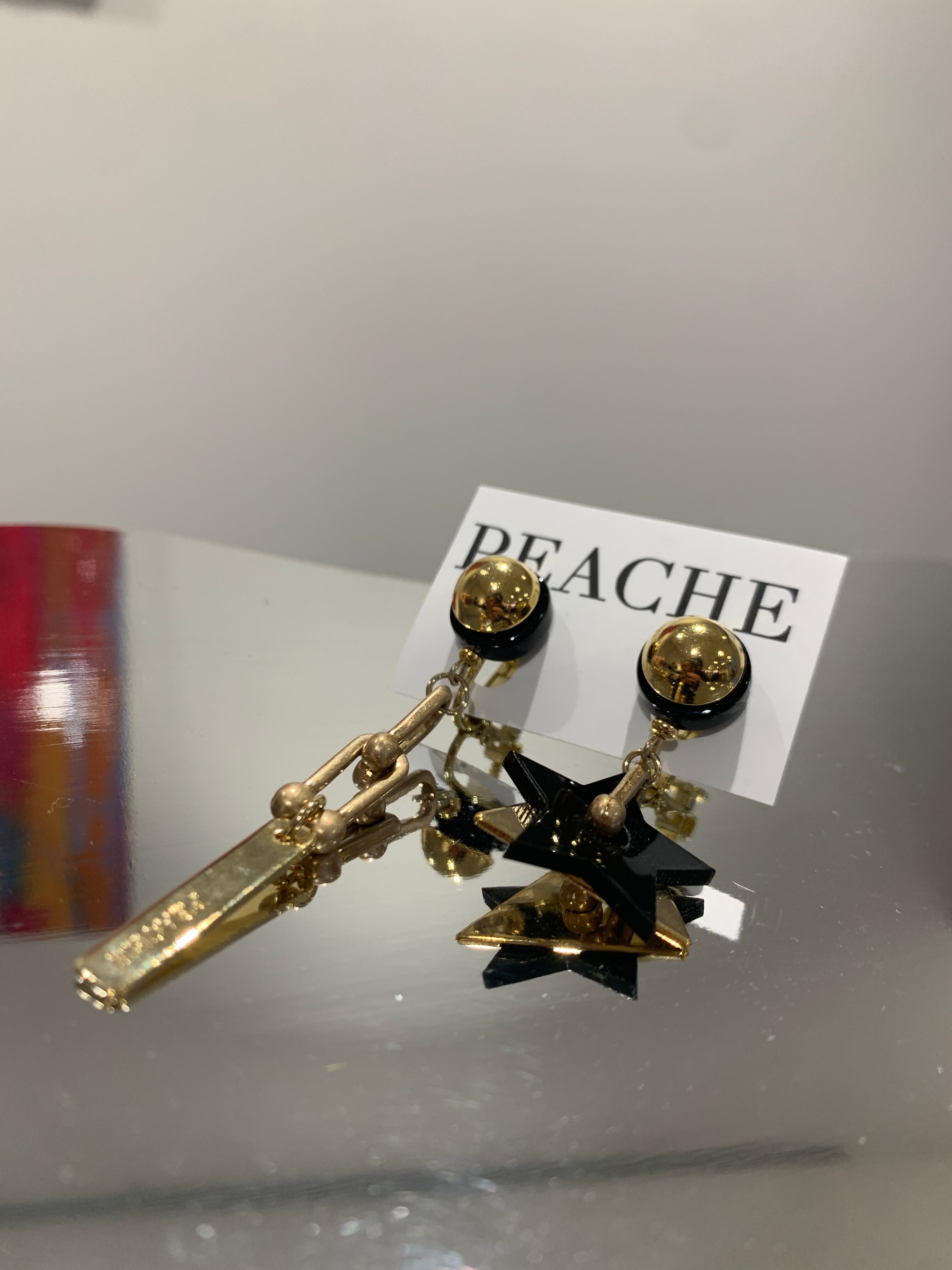 asymmetry mat gold chain black star