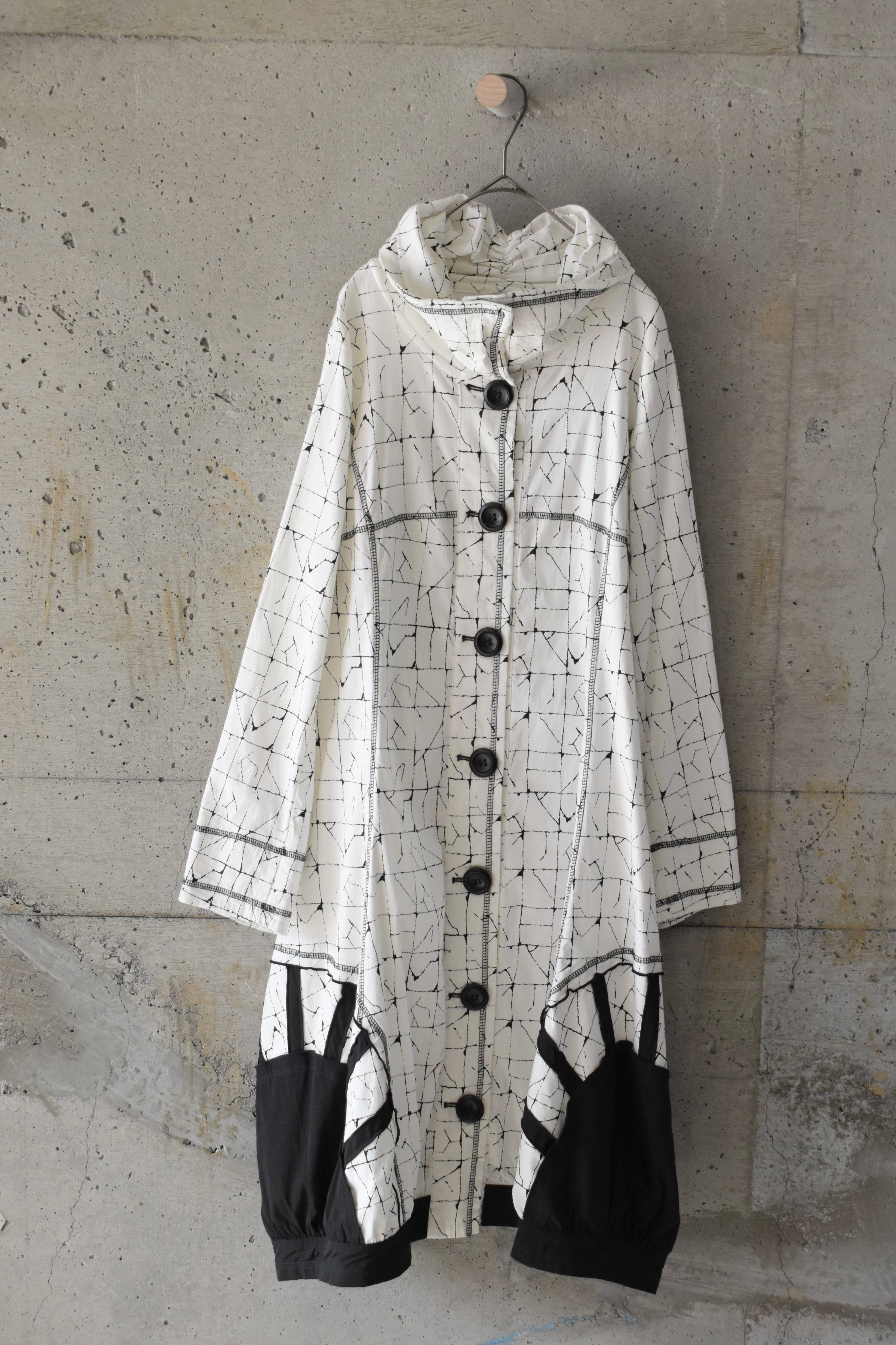 Geometric coat with rounded hem
