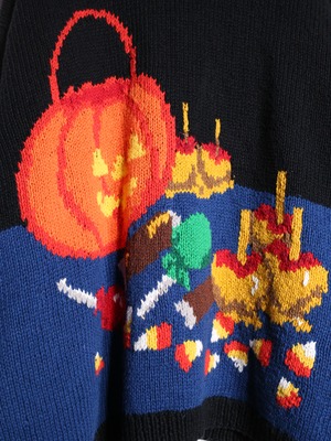 halloween motif graphic design XXX over silhouette cardigan