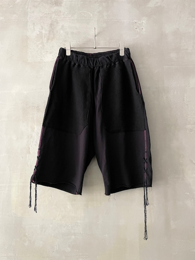 TrAnsference inside-out pile twin patch pocket dangling cord hem shorts - complete black garment dyed
