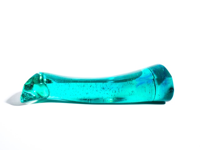 A streamlined, turquoise-blue glass object