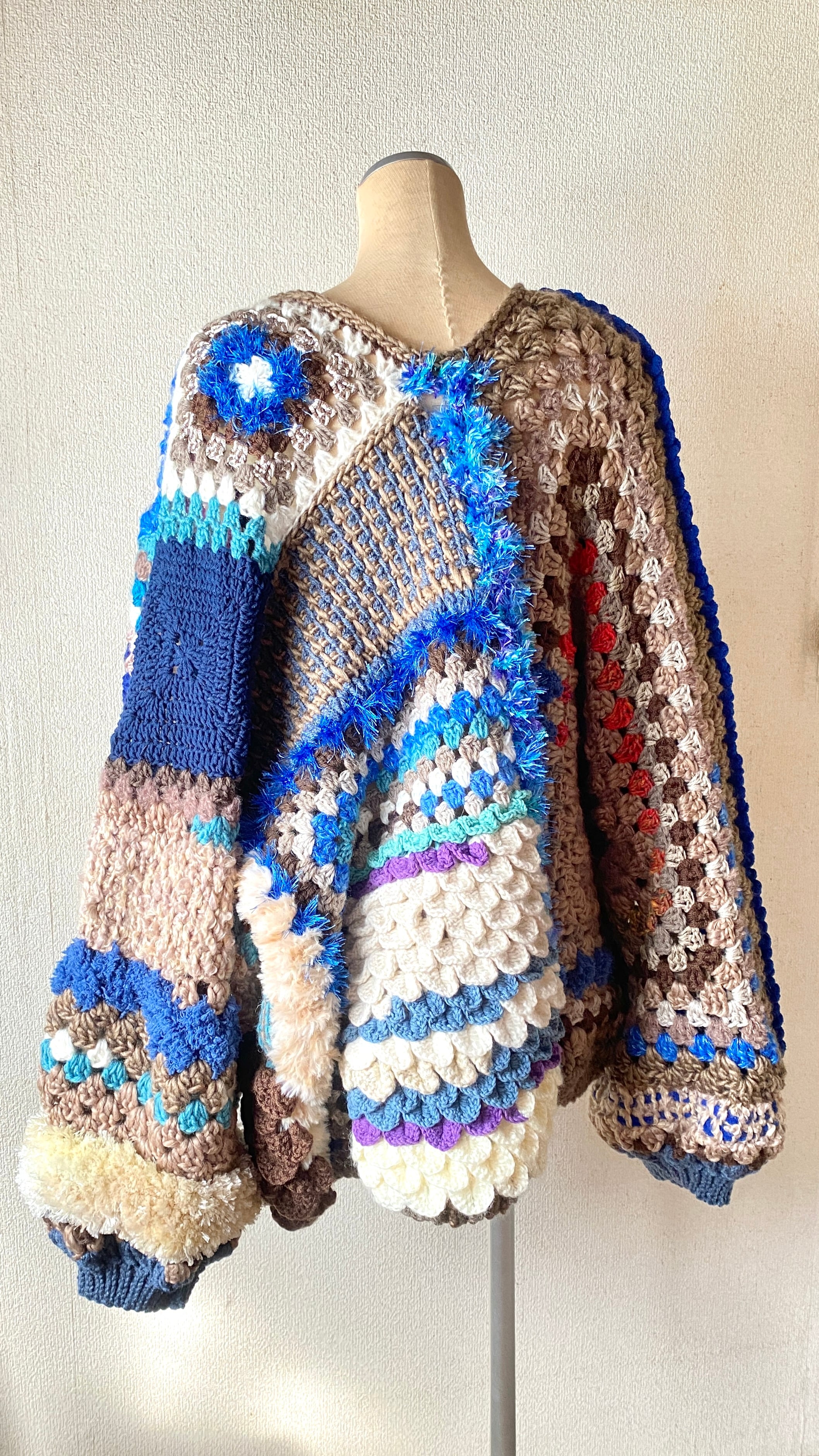 Crocheted granny hexagon and square motif asymmetrical cardigan