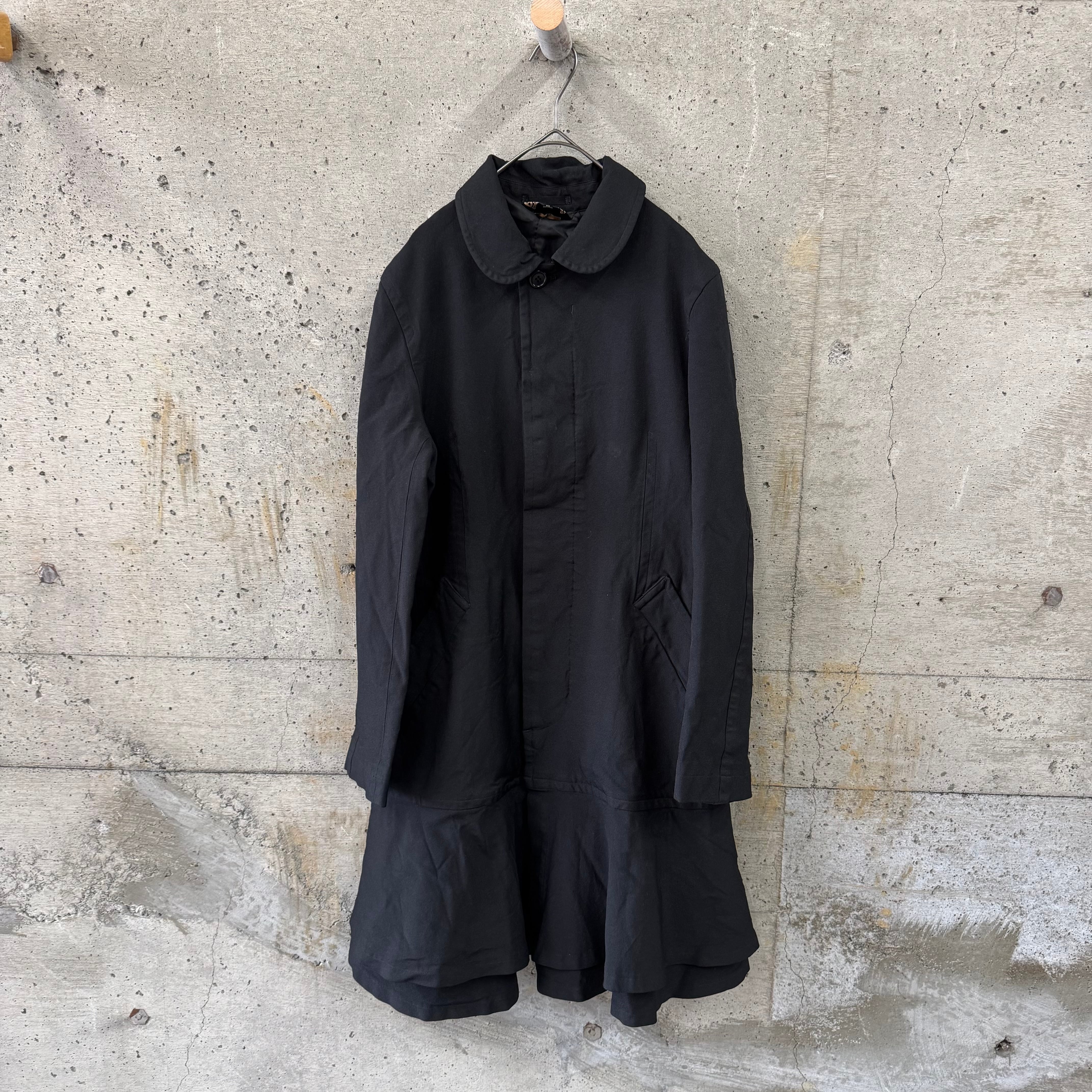 Stretch coat with ruffled hem