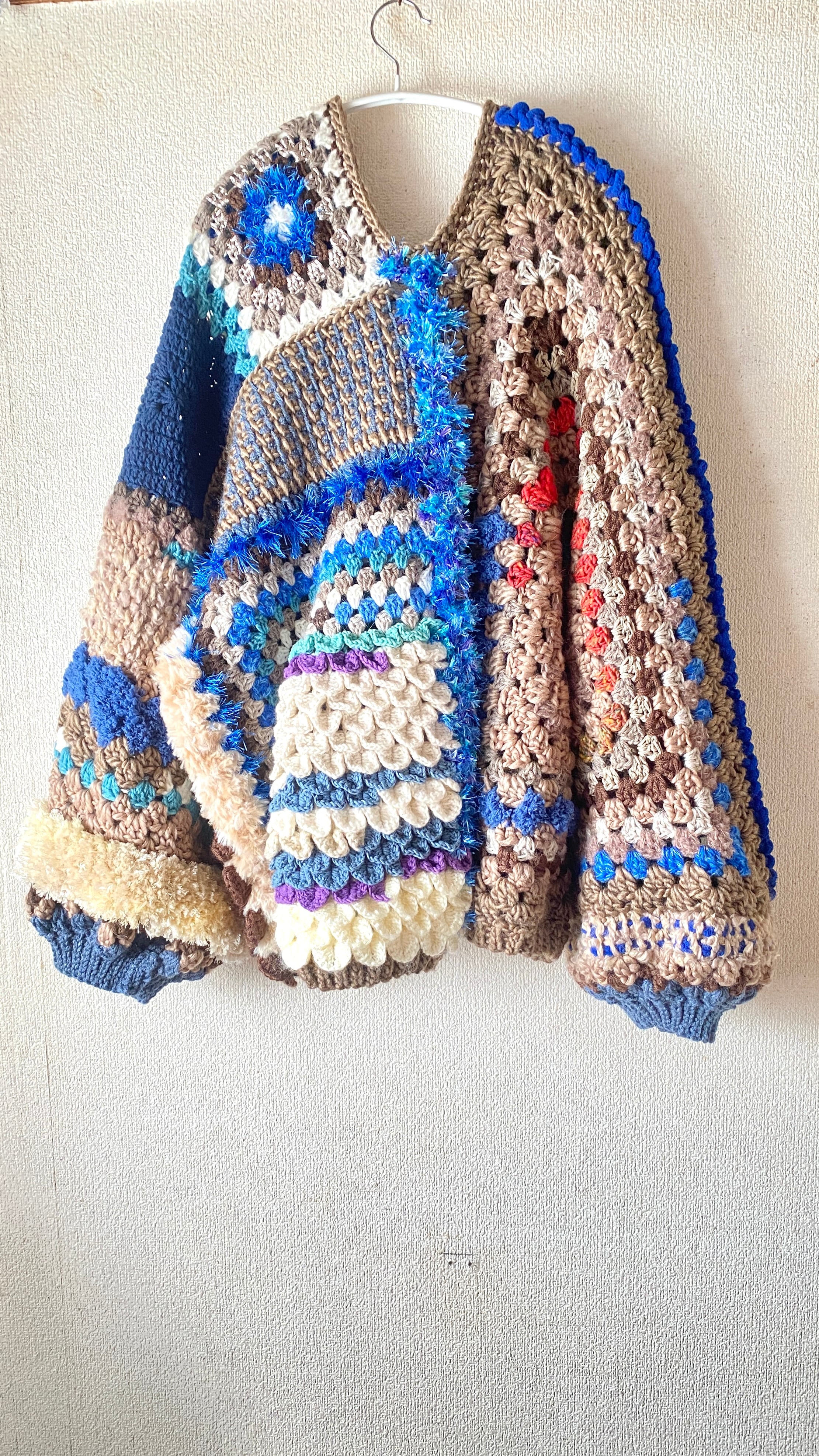 Crocheted granny hexagon and square motif asymmetrical cardigan