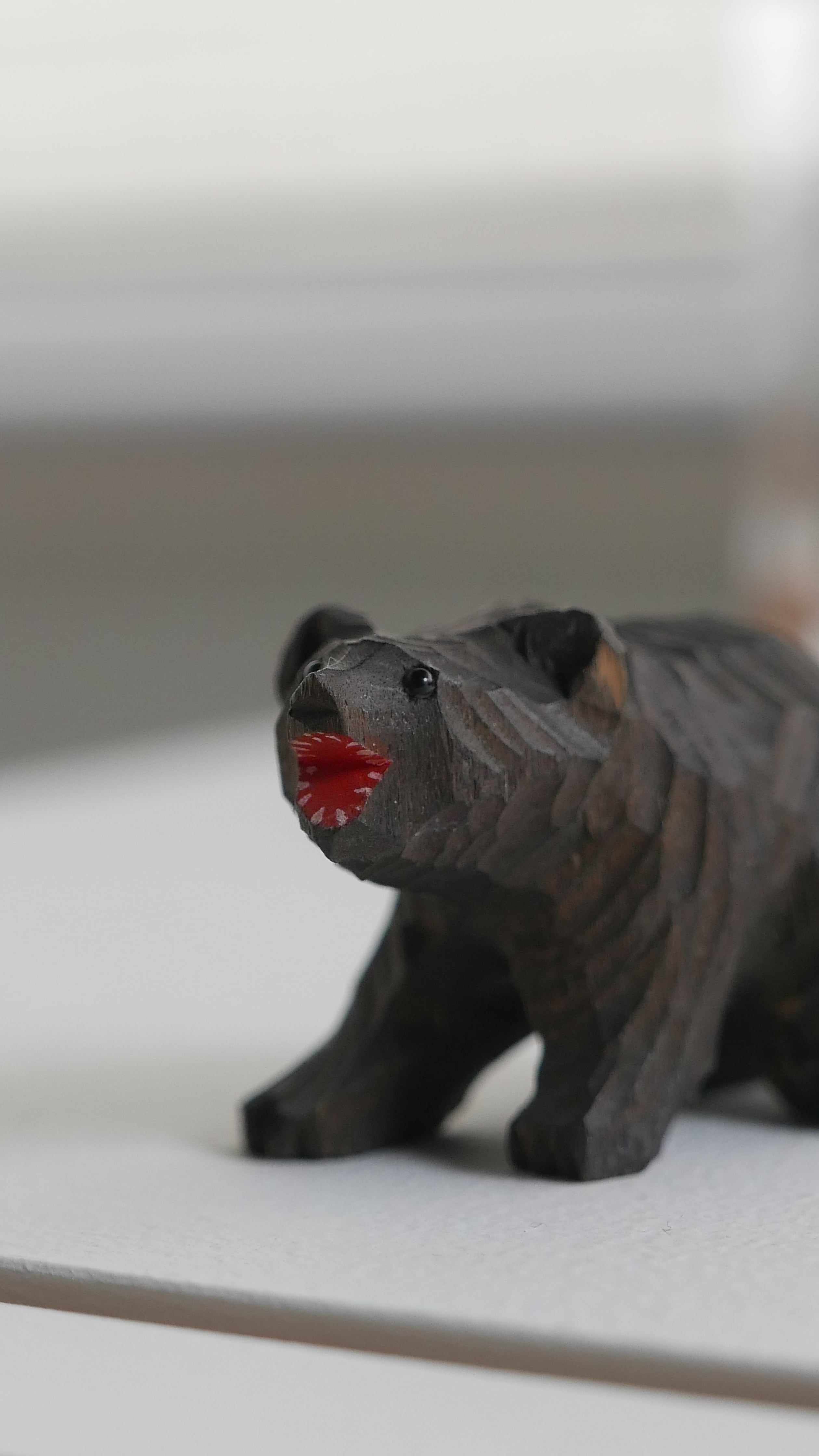 old japan , small wooden bear ,  red mouth