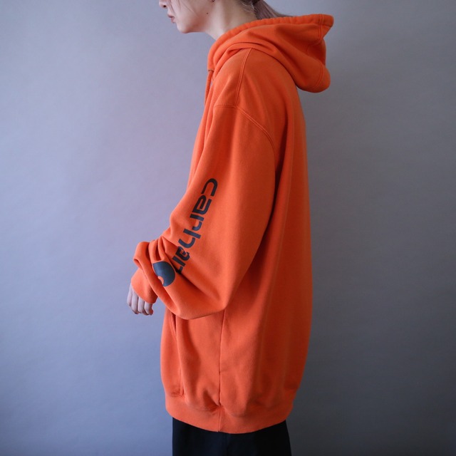 "Carhartt" sleeve logo printed over silhouette orange sweat parka