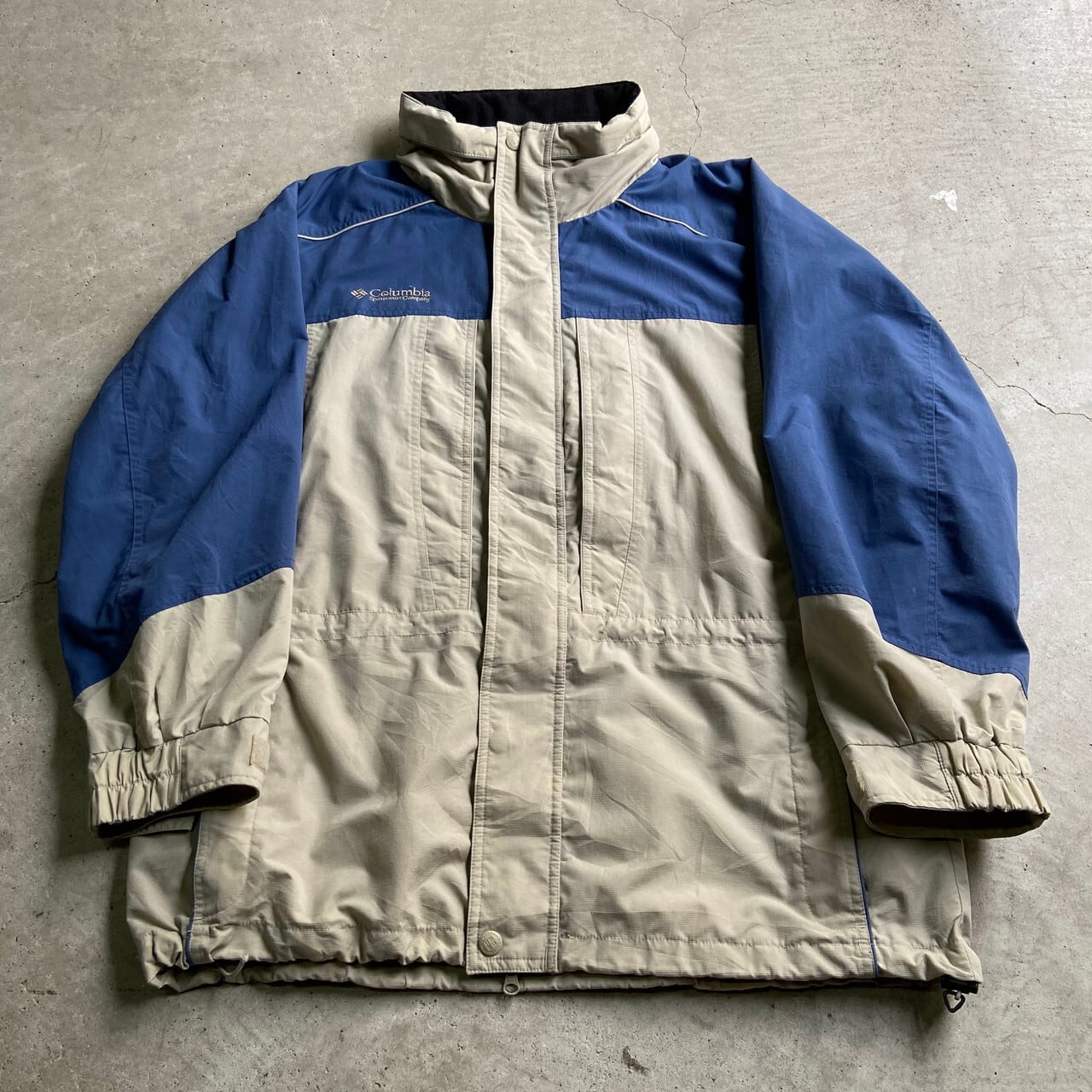 ビッグサイズ Columbia コロンビア アウトドアジャケット マウンテンパーカー メンズ2xl相当 ワンポイントロゴ刺繍 古着 フード収納型 ナイロンジャケット ダストブルー ベージュ 青色 大きいサイズ アウトドアジャケット Al2110 Cave 古着屋 公式 古着通販サイト