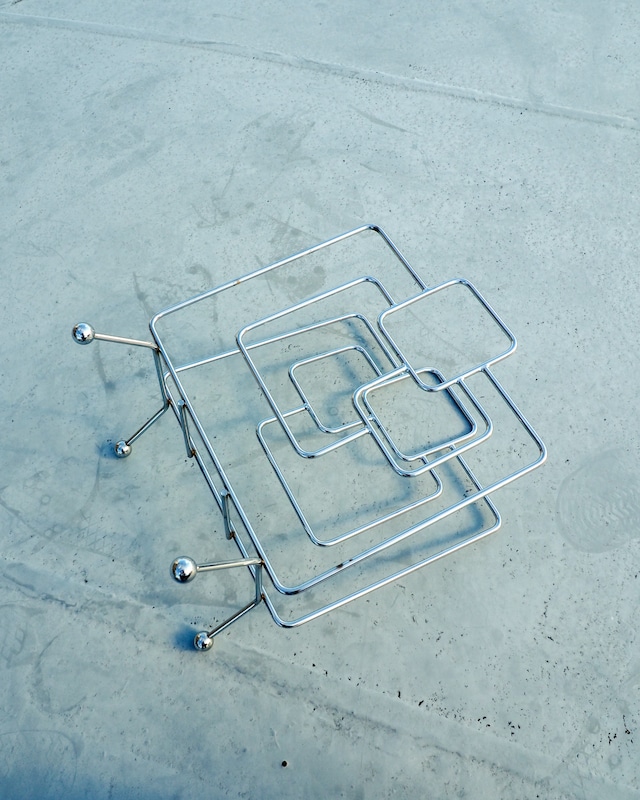 Chrome-plated geometric wireframe magazine rack