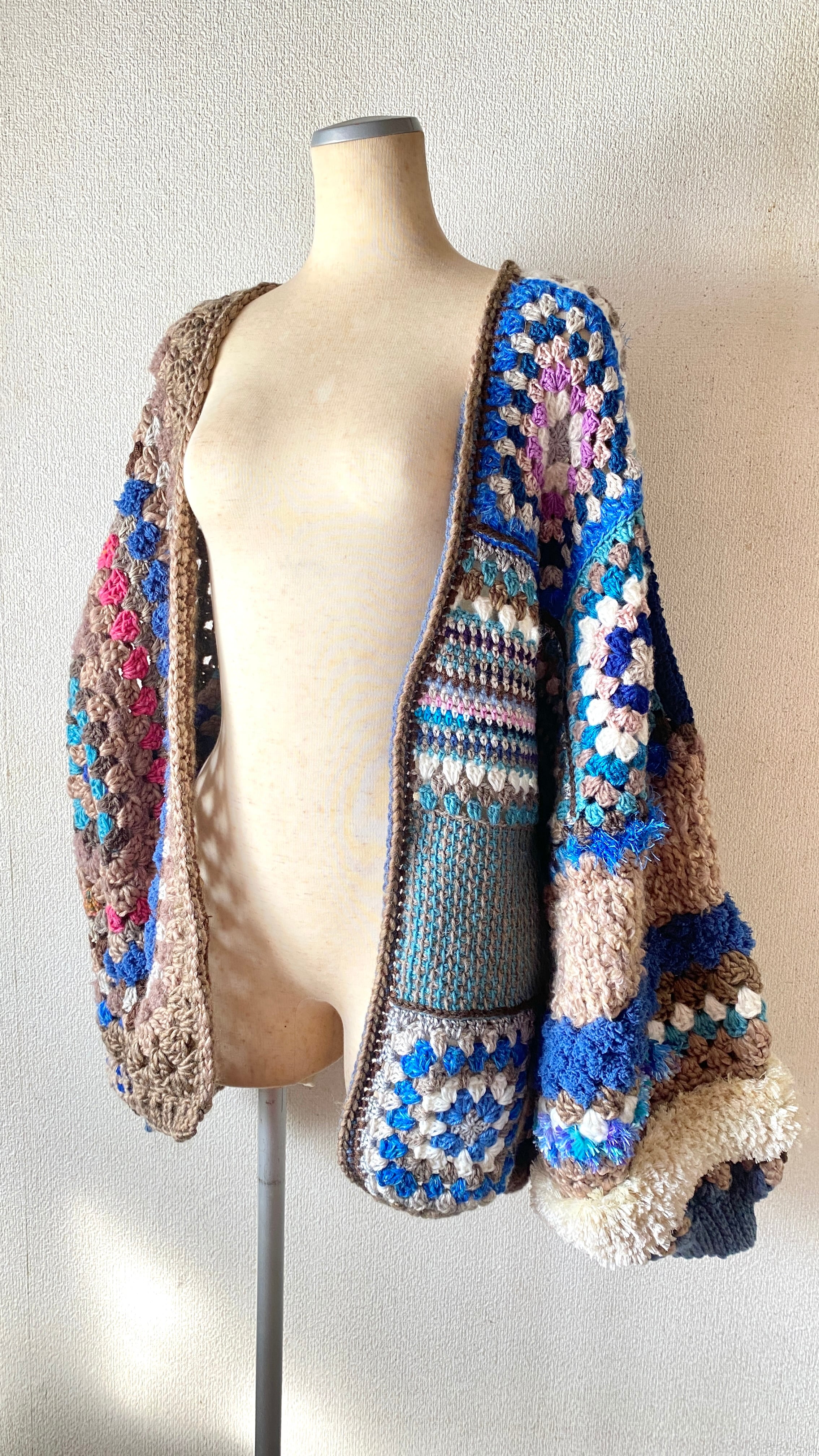 Crocheted granny hexagon and square motif asymmetrical cardigan